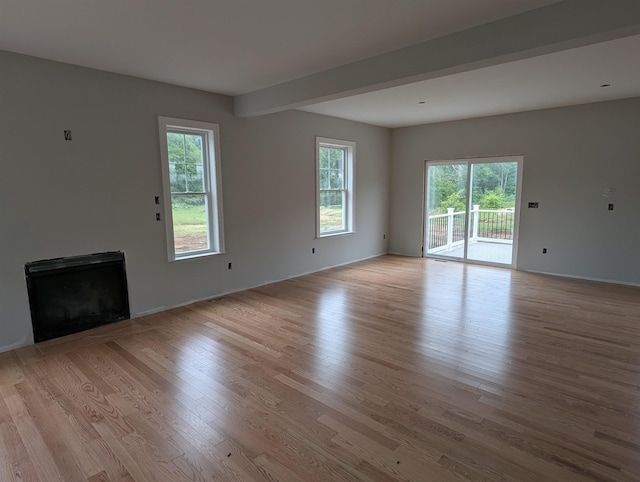 LOT7-3 Sanborn Mdw Unit 7-3, Fremont, NH 03044 - unfurnished living room featuring light wood-type flooring, a fireplace, and baseboards