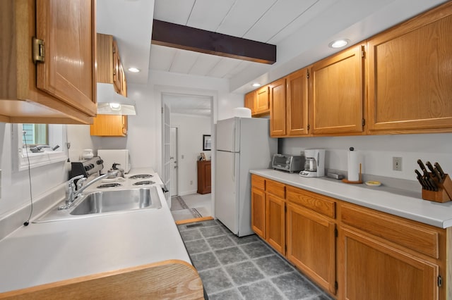 180 Ash St, Conway, NH 03860 - kitchen featuring under cabinet range hood, freestanding refrigerator, light countertops, a sink, and dark floors