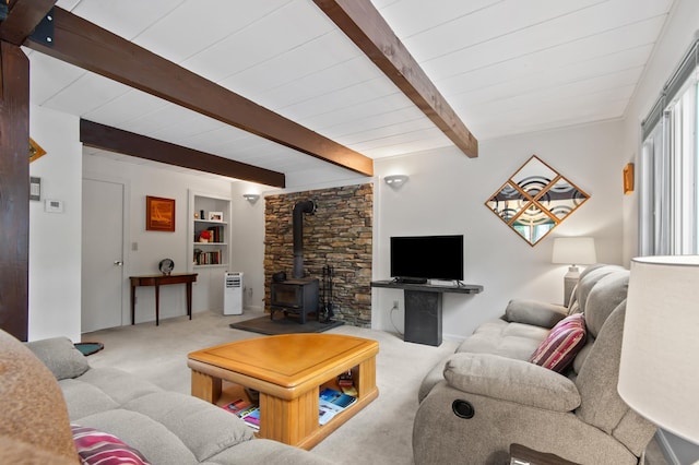 180 Ash St, Conway, NH 03860 - living area featuring a wood stove, carpet flooring, beamed ceiling, and built in shelves