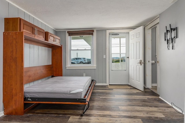 522 Ocean Blvd Unit 10, Hampton, NH 03842 - bedroom with wood finished floors, a textured ceiling, baseboards, and access to outside