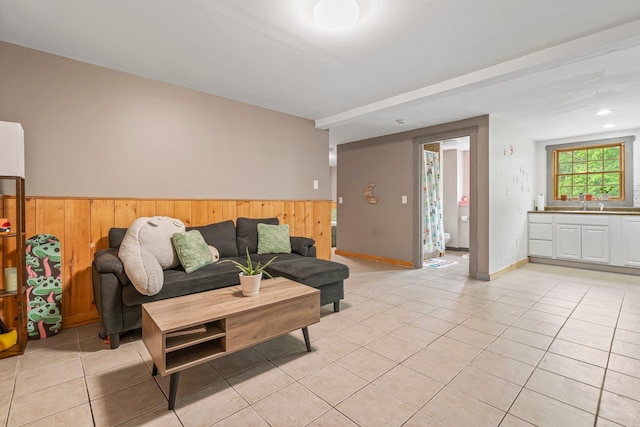 290 Cornish Tpke, Newport, NH 03773 - living area featuring wooden walls, light tile patterned floors, and a wainscoted wall