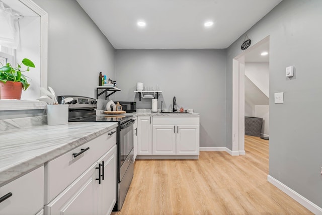 290 Cornish Tpke, Newport, NH 03773 - kitchen featuring electric range, a sink, light wood-style floors, white cabinets, and recessed lighting