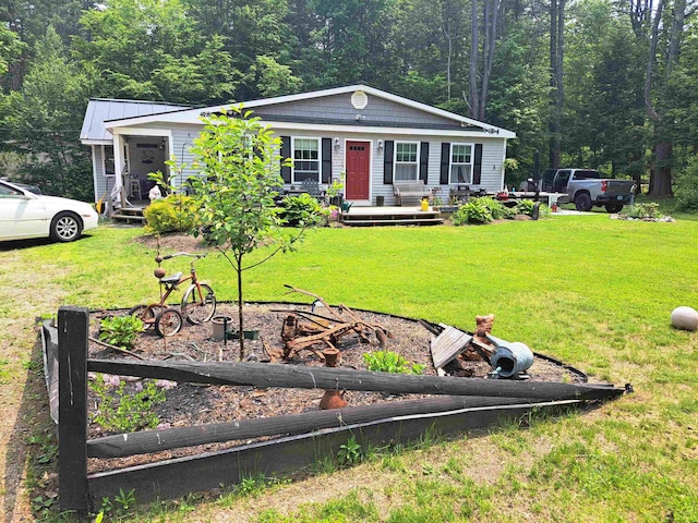 3 Osullivan Way, Ossipee, NH 03814 - view of front of house featuring covered porch, a front lawn, and a forest view