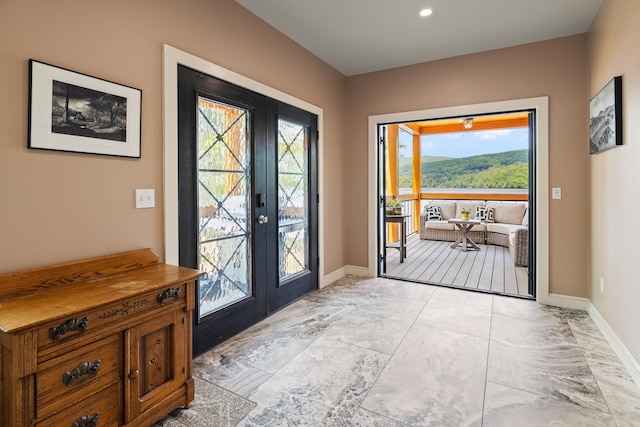 111 Nh Route 4a, Enfield, NH 03748 - doorway to outside featuring french doors, baseboards, and light marble finish floors