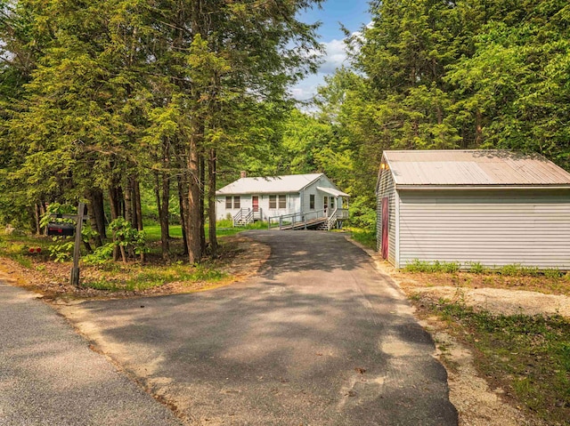 95 Priest Rd, Nottingham, NH 03290 - view of front of property featuring asphalt driveway, metal roof, and an outbuilding