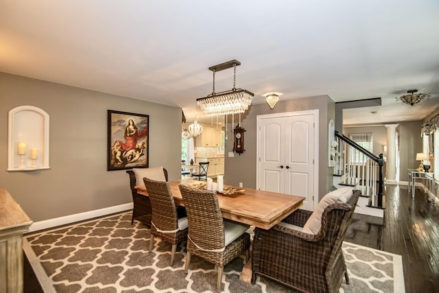 4 Crossman Cir, Newton, NH 03858 - dining area featuring stairs, decorative columns, baseboards, dark wood-style flooring, and a chandelier