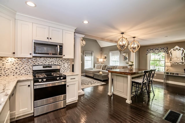4 Crossman Cir, Newton, NH 03858 - kitchen with stainless steel appliances, white cabinets, decorative backsplash, a chandelier, and open floor plan