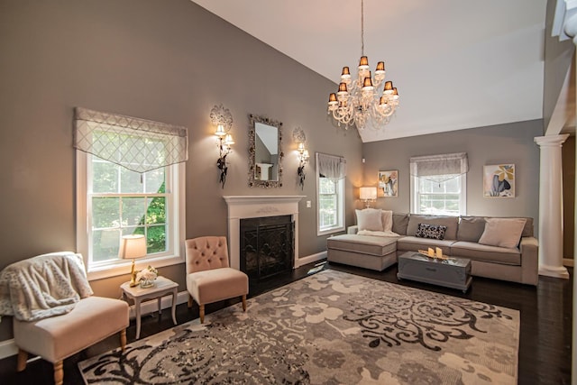 4 Crossman Cir, Newton, NH 03858 - living area with wood finished floors, high vaulted ceiling, baseboards, a fireplace with flush hearth, and a chandelier