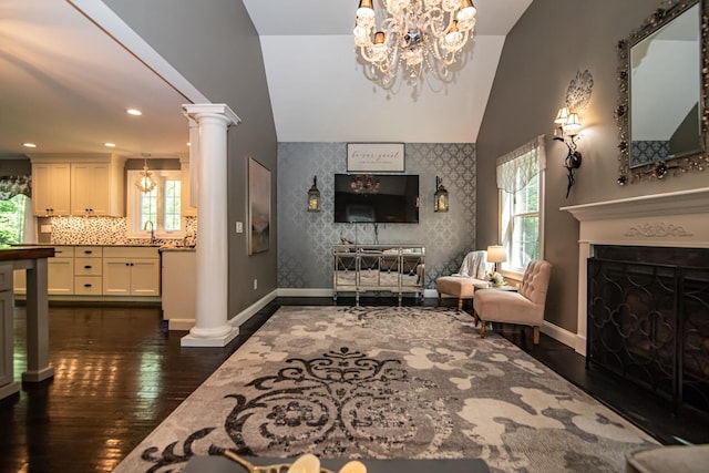 4 Crossman Cir, Newton, NH 03858 - living room with lofted ceiling, healthy amount of natural light, dark wood-style flooring, baseboards, and decorative columns
