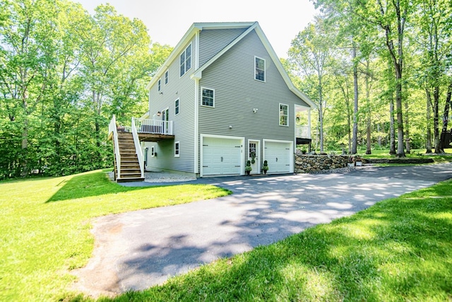 4 Crossman Cir, Newton, NH 03858 - view of side of property featuring stairs, an attached garage, driveway, a wooden deck, and a yard