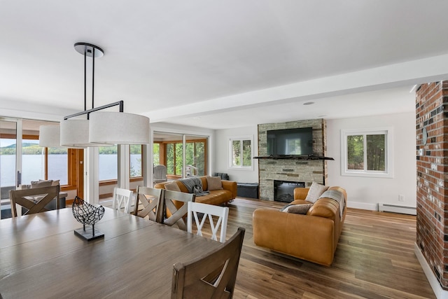 6 Paquette Ln, Sunapee, NH 03782 - dining room featuring a baseboard radiator, a fireplace, wood finished floors, and baseboards