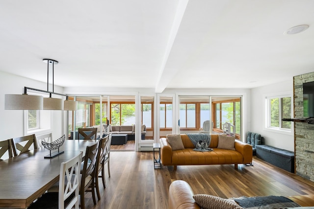6 Paquette Ln, Sunapee, NH 03782 - living area featuring wood finished floors, beam ceiling, and a baseboard heating unit