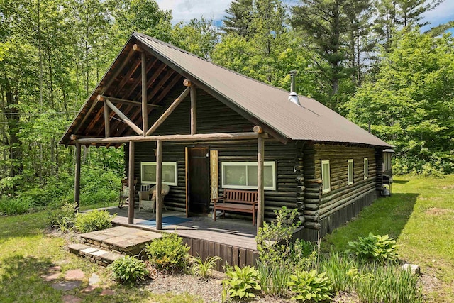 230 Pine Hill Rd, Ossipee, NH 03864 - log-style house featuring log siding, metal roof, and a wooden deck