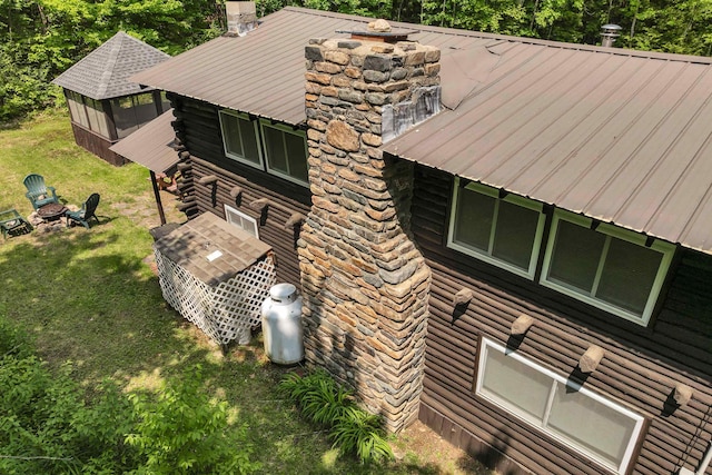 230 Pine Hill Rd, Ossipee, NH 03864 - view of side of home featuring a fire pit, metal roof, a yard, and a chimney