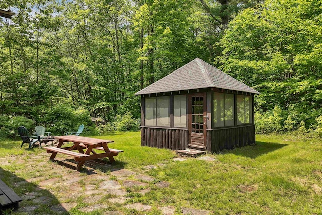 230 Pine Hill Rd, Ossipee, NH 03864 - view of outdoor structure with a forest view, an outdoor fire pit, and a sunroom