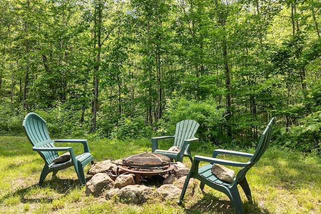 230 Pine Hill Rd, Ossipee, NH 03864 - view of yard featuring an outdoor fire pit and a wooded view
