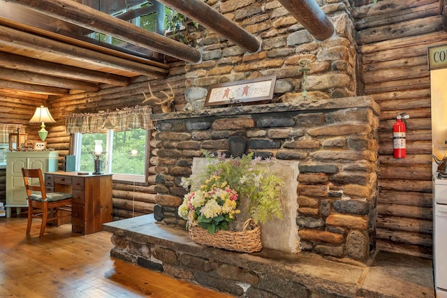 230 Pine Hill Rd, Ossipee, NH 03864 - living room featuring log walls, wood-type flooring, and beam ceiling