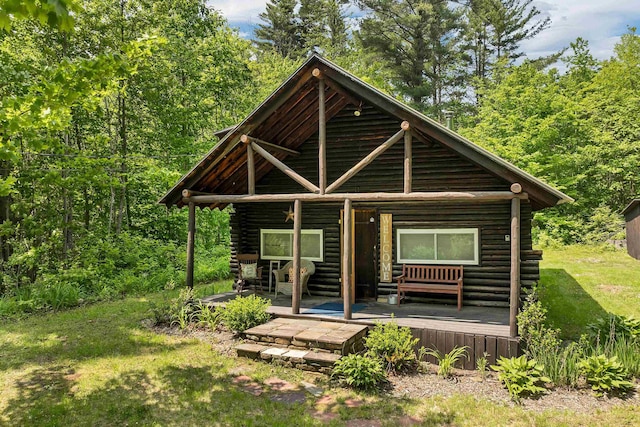 230 Pine Hill Rd, Ossipee, NH 03864 - log-style house with log siding and a wooden deck