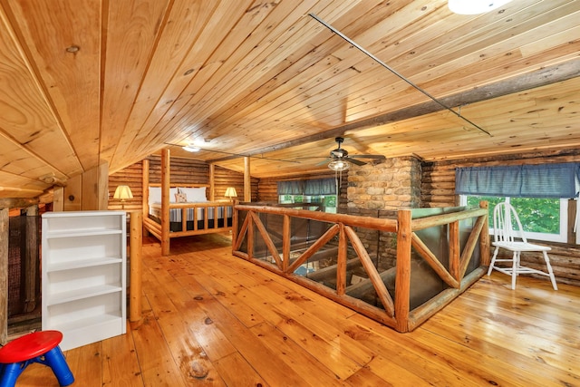230 Pine Hill Rd, Ossipee, NH 03864 - unfurnished room with an upstairs landing, wood ceiling, log walls, hardwood / wood-style floors, and a ceiling fan