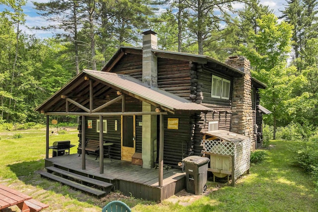 230 Pine Hill Rd, Ossipee, NH 03864 - back of property featuring a chimney, log siding, a yard, and a deck