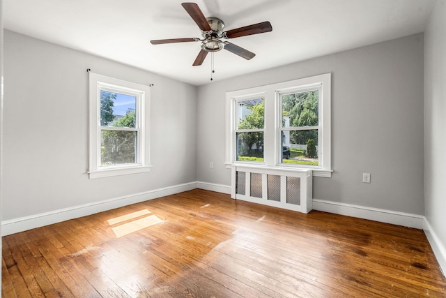33 Hayes Ave, Manchester, NH 03103 - spare room featuring radiator, hardwood / wood-style flooring, baseboards, and a ceiling fan