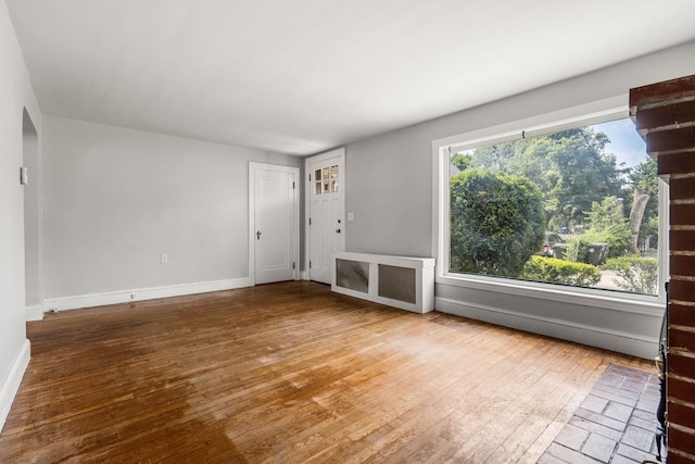 33 Hayes Ave, Manchester, NH 03103 - unfurnished living room with hardwood / wood-style flooring and baseboards