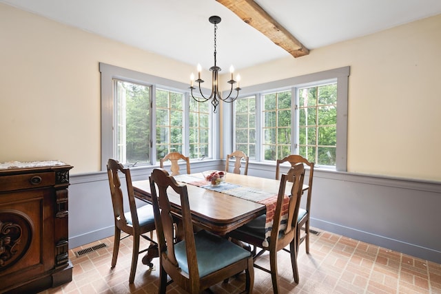 183 Mountain View Rd, Whitefield, NH 03598 - dining space featuring a chandelier, brick patterned flooring, beamed ceiling, and wainscoting