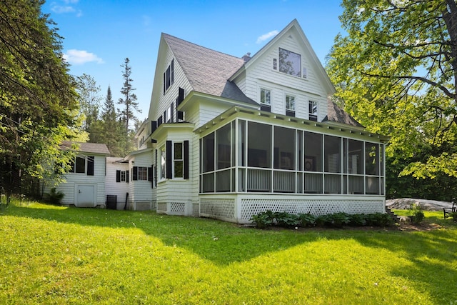 183 Mountain View Rd, Whitefield, NH 03598 - rear view of property with a sunroom, a shingled roof, and a yard