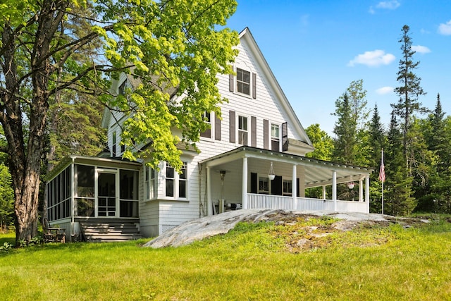 183 Mountain View Rd, Whitefield, NH 03598 - back of house with a sunroom, a lawn, and covered porch