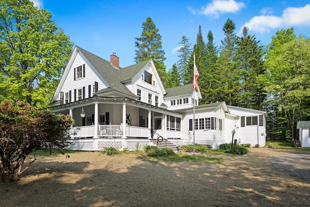 183 Mountain View Rd, Whitefield, NH 03598 - view of front of home featuring a shingled roof, covered porch, and a chimney