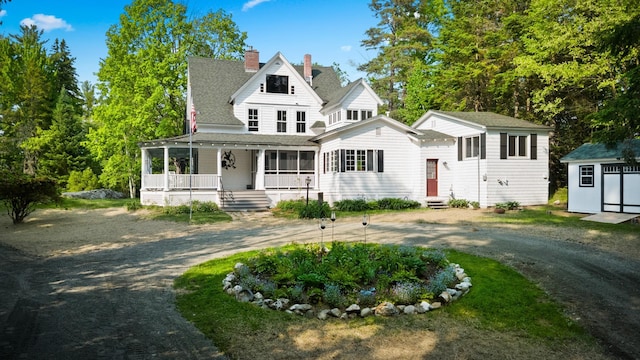 183 Mountain View Rd, Whitefield, NH 03598 - view of front facade with a porch, curved driveway, a chimney, and a shingled roof