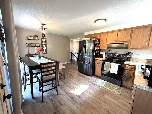 4 Mount Vernon Dr, Pelham, NH 03076 - kitchen featuring black electric range, under cabinet range hood, fridge with ice dispenser, light wood-type flooring, and light countertops