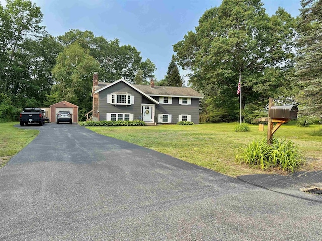 4 Mount Vernon Dr, Pelham, NH 03076 - bi-level home featuring a chimney, an outdoor structure, a detached garage, a front yard, and driveway