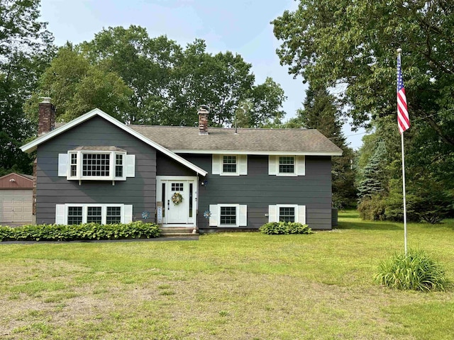 4 Mount Vernon Dr, Pelham, NH 03076 - split foyer home featuring a chimney, a front lawn, a garage, and an outdoor structure