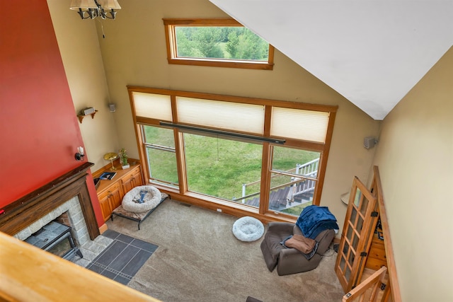 190 Ledge Hill Rd, Tuftonboro, NH 03816 - carpeted living area featuring a fireplace with flush hearth, a chandelier, and lofted ceiling