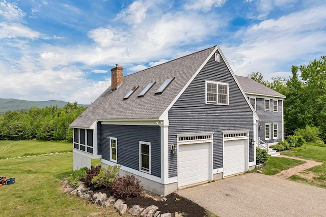 190 Ledge Hill Rd, Tuftonboro, NH 03816 - view of side of home featuring roof with shingles, a chimney, driveway, and a lawn