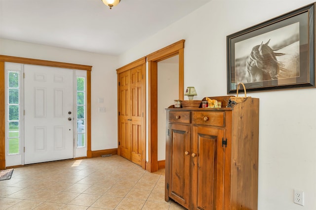 190 Ledge Hill Rd, Tuftonboro, NH 03816 - entrance foyer with light tile patterned floors and baseboards