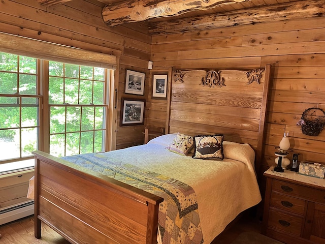27 Stearns Ave, Wilmington, VT 05363 - bedroom with multiple windows, wooden walls, a baseboard heating unit, and light wood finished floors