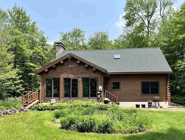 27 Stearns Ave, Wilmington, VT 05363 - back of house featuring a chimney, a lawn, a shingled roof, and log exterior