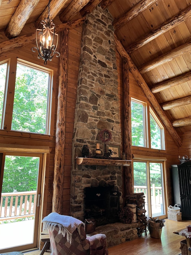 27 Stearns Ave, Wilmington, VT 05363 - living room featuring a wood ceiling with exposed beams, hardwood / wood-style flooring, high vaulted ceiling, a chandelier, and wooden walls