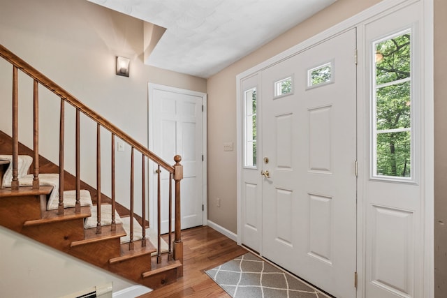 6 Bona Vista Dr, Bow, NH 03304 - foyer entrance featuring wood finished floors, baseboards, stairway, and a baseboard heating unit