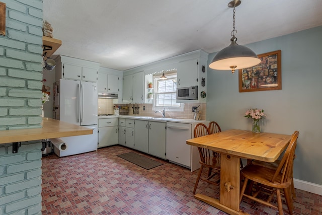 15 Allens Ave, Lee, NH 03861 - kitchen featuring white appliances, backsplash, under cabinet range hood, light countertops, and a sink