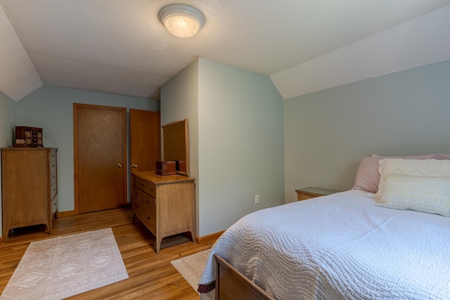 15 Allens Ave, Lee, NH 03861 - bedroom with lofted ceiling and light wood-style flooring