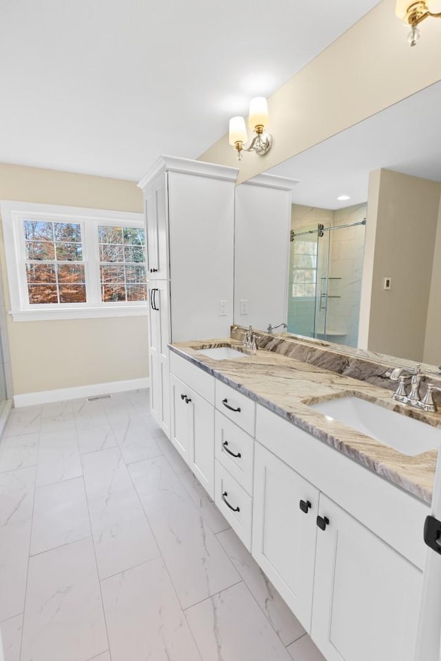 70 Hatch Corner Rd, Meredith, NH 03253 - full bathroom with a stall shower, baseboards, double vanity, and marble look tiles