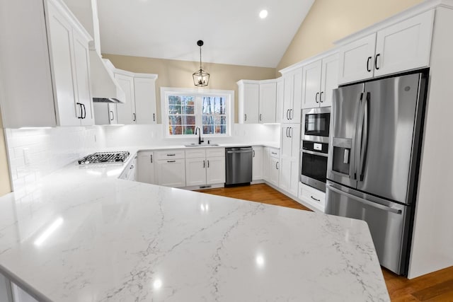 70 Hatch Corner Rd, Meredith, NH 03253 - kitchen featuring appliances with stainless steel finishes, a sink, backsplash, light stone countertops, and vaulted ceiling