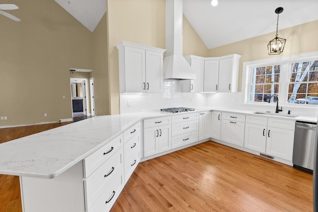 70 Hatch Corner Rd, Meredith, NH 03253 - kitchen with a sink, stainless steel appliances, wall chimney exhaust hood, a peninsula, and tasteful backsplash