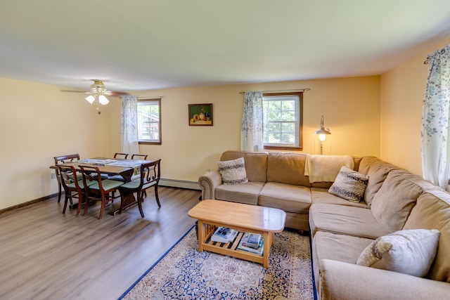 10 Mountain View Ter, Plymouth, NH 03264 - living room featuring baseboard heating, light wood-type flooring, baseboards, and a ceiling fan
