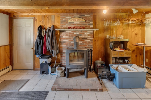 10 Mountain View Ter, Plymouth, NH 03264 - living area with wood ceiling, wood walls, a wood stove, tile patterned flooring, and a baseboard radiator