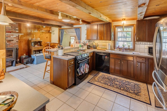 10 Mountain View Ter, Plymouth, NH 03264 - kitchen with black appliances, wooden ceiling with exposed beams, a peninsula, decorative backsplash, and light tile patterned floors