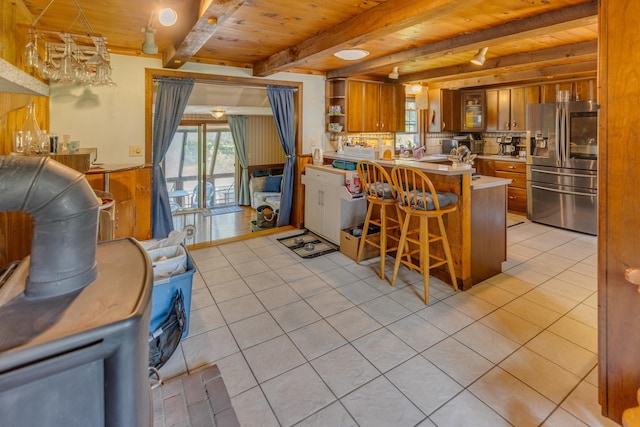 10 Mountain View Ter, Plymouth, NH 03264 - kitchen featuring stainless steel fridge, wooden ceiling with exposed beams, brown cabinetry, light tile patterned floors, and open shelves